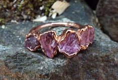 Great ring with applied raw rhodolite crystals, which were set in copper using electroforming. Each ring is shipped in eco-friendly gift packaging. You will receive the ring pictured above or a comparable one. ---------------------------------------------------------------------------------------------------------- Rhodolite | raw rhodolite ring | Rhodolite Crystal | Electroformed | Copper Ring | Raw rhodolite crystals have been electroformed into a hand hammered copper ring. Every stone is as u Bohemian Rings With Raw Stone, Unique Crystal Ring With Raw Stone For Promises, Rhodolite Ring, Raw Garnet, Environmentally Friendly Gifts, Tiny Studio, Copper Ring, Garnet Ring, Ring Pictures