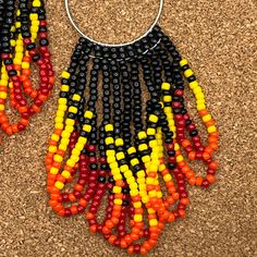 Flaming hot versatile beaded earrings to add flair to your Halloween outfit and even after into the fall season, they would make a nice gift for someone special. Don't forget someone with a fire sign or element. Each beaded earring is meticulously made one bead at a time. No two are ever the same. They hang at 3 3/4 inches including the ear wire and are about 1 inch wide. Flaming Hot, Beaded Earring, Fire Signs, Red Orange Yellow, Halloween Outfit, M F, Drop Beads, Tassel Fringe, Jewelry Earrings Hoops