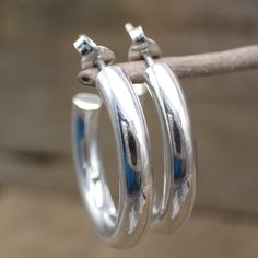 These sterling silver post hoop earrings are perfect for everyday wear. Intricately crafted from sterling silver, the simple design will add a bit of sparkle to any outfit. Simple and stylish, they are sure to become a staple in any jewelry collection. Dimensions: 25 mm x 25 mm Classic Silver Rounded Jewelry, Classic Rounded Silver Jewelry, Small Silver Hoop Earrings Hallmarked, Hypoallergenic Sterling Silver Hoop Earrings For Anniversary, Everyday Rounded Earrings With Polished Finish, Everyday Rounded Polished Earrings, Everyday Polished Rounded Earrings, Classic Small Hoop 925 Silver Earrings, Classic Hoop Earrings Stamped 925 For Anniversary