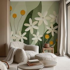 a living room with flowers painted on the wall and white furniture in front of it