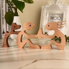 two wooden figurines sitting next to each other