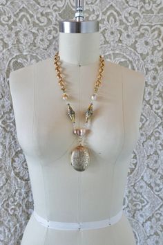 This beautiful necklace is made from large vintage mid century gold filled locket from Thailand. It is set with freshwater baroque pearls, vintage Turkmen beads, and mid century gold filled hollow formed chain. All these pieces come together to make a lovely mixed metal necklace with heirloom appeal.  All pieces are unique. They are made completely from found and recycled parts, much like found-object art. I have loved jewelry my whole life. I want to create pieces that drape and lay on the body the way clothing would, using relics and totems from years past. Jewelry you'd see a rockstar wear... Jewelry that requires guts, soul, and thought... www.reckless-daughter.com Antique Gold Pearl Chain Necklace, Vintage Gold Jewelry With Pearl Charm, Gold Necklace With Pearl Charm, Unique Gold Necklace With Pearl Charm, Vintage Pendant Necklace With Pearl Chain, Vintage Pearl Pendant Medallion Jewelry, Vintage Gold Pearl Drop Necklace, Vintage Gold Pearl Necklace With Pearl Drop, Antique Gold Pearl Drop Necklace