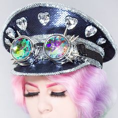 The Party Is The Love Of Your Life With The Destiny Bond Sequin Captain Hat From Lasr. These Glam Rave Festival Hats Feature A Full-On Black Sequin Captain Style Hat With A Gem-Encrusted Front, Removable Kaleidoscopic Spike Goggles, And Elastic Chin Strap To Keep That Hat On While You're Partying Til' The Sun Comes Up. Music Will Never Break Your Heart! "Destiny Bond Sequin Captain Hat Rhinestone, Metal Studs Accents Heart Gem Brouch-Like Decors Sequin Fabric In The Back Removable Spiked Kaleido Fun Party Costume Cap, Fun Brimmed Costume Hats For Parties, Punk Style Party Cap Hat, Fun Mini Cap Hats For Party, Trendy Multicolor Party Hat, Adjustable Punk Costume Hats And Headpieces, Adjustable Punk Style Costume Hats And Headpieces, Fitted Mini Party Cap, Fitted Mini Cap For Party