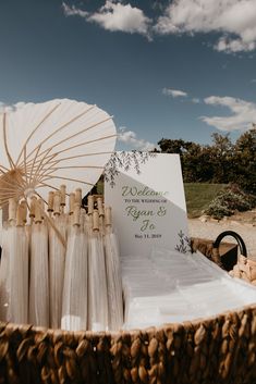 a basket filled with wedding favors and an umbrella