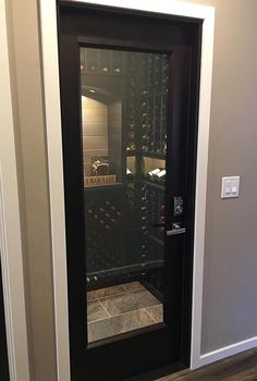 the door is open to reveal a wine cellar