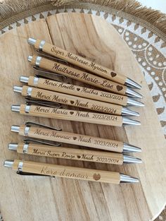 six wooden spoons with engraved names on them sitting on a table next to each other