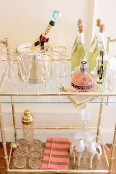 a bar cart filled with champagne bottles and glasses