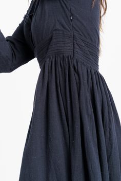 A hint of vintage to your classic black dress. This semi-formal dress fits like a dream with adorable delicate gathers around the waist, relax-fitted long sleeves, and an overlapping neckline. Tailored from handcrafted organic cotton fabric, this dress is a modern piece with a nostalgic sensibility. The fitted empire waistline will let you flaunt your curves elegantly. Fits true to size Side pockets Falls 45" from the high point of the shoulder Made in organic cotton Machine wash The model is ch Overlapping Neckline, Fit And Flare Midi Dress, Flare Midi Dress, Classic Black Dress, Semi Formal Dress, Empire Waistline, Office Dresses, Mid Dresses, Organic Cotton Fabric