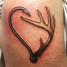 a deer antler tattoo on the back of a man's thigh