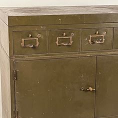 an old metal cabinet with four drawers