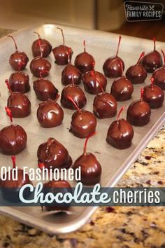 chocolate covered cherries on a baking sheet ready to be baked in the oven for christmas