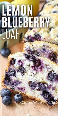 lemon blueberry loaf on a cutting board with fresh blueberries