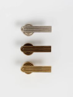 three different types of door handles on a white surface