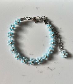 Need some wedding luck with 'Something Blue' flower beaded bracelet or style as an anklet! Inspired by the delicate romance of weddings, this beauty is all about love, purity, and positivity. With its pastel blue and silver colours and intricate beading, it's your perfect good luck charm and bridal accessory for your wedding or a cute hint for your baby shower. Bring some wedding luck to your day or baby shower with this beaded bracelet / anklet.  Explore more items like this at Dainty and Shine Light Blue Beaded Flower Jewelry, Light Blue Flower-shaped Beaded Jewelry, Spring Blue Beaded Bracelets, Blue Beaded Bracelets For Spring, Adjustable Blue Beaded Bracelets For Wedding, Blue Beaded Bracelets As Spring Gift, Blue Beaded Bracelets For Spring Gift, Handmade Blue Beaded Bracelets For Spring, Spring Wedding Blue Jewelry