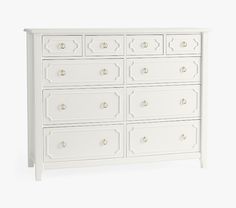 a white dresser with many drawers and knobs on the top, in front of a white background