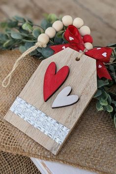 an ornament with two hearts and a bow on top of burlock