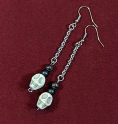 Dangle skull bead earrings. Hangs on a stainless steel chain, with a stainless steel earring hook. Dangle length is 2 1/2 inches, but can be adjusted to any length. If you would like a customized length, please message me or leave a note in your order. Punk Dangle Jewelry With Adjustable Chain, Punk Hypoallergenic Dangle Jewelry, Hypoallergenic Punk Dangle Earrings, Hypoallergenic Punk Dangle Jewelry, Hypoallergenic Dangle Earrings In Punk Style, Punk Style Dangle Earrings With Ear Wire, Edgy Nickel-free Skull Earrings, Edgy Dangle Jewelry With Adjustable Chain, Handmade Punk Dangle Jewelry