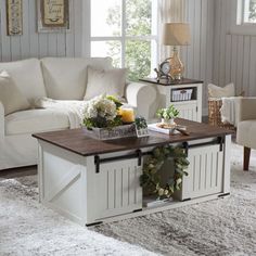 a living room with a white couch and coffee table