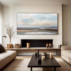 a living room filled with furniture and a large painting on the wall above it's fireplace