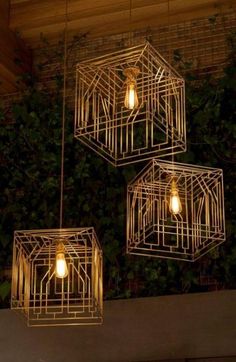 three golden cages with light bulbs hanging from them