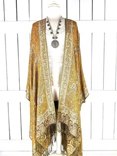 Gold grey paisley pashmina kimono cover up jacket with custom length and fringe detail Measurements...taken flat - width across seam to seam: 53" - regular length with fringe: 38"  - regular length without fringe: 34"  - Maxi length is as selected with or without fringe -length in photo: 38" Features... - lovely soft woven medium weigh pashmina fabric - bohemian oversized flowing design - cardigan style with an open front and generous arm holes  - universal design allows a comfortable fit for sm Elegant Fall Shawl With Tassels, Bohemian Fall Kimono With Tassels, Bohemian Shawl Kimono With Fringe, Bohemian Kimono With Fringe Shawl, Bohemian Fringe Kimono For Fall, Fall Bohemian Fringe Kimono, Bohemian Tassel Kimono For Fall, Bohemian Pashmina Shawl For Fall, Fall Bohemian Pashmina Shawl In One Size