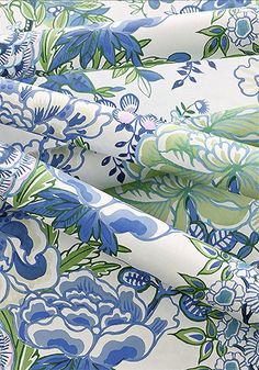 blue and green floral print on white fabric with large flowered flowers in the center