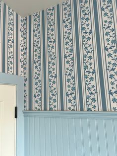 a blue and white striped wallpaper in a room