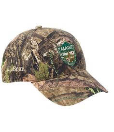 In soft, brushed cotton camouflage twill and featuring a richly embroidered logo, wearing the Maine fisheries and wildlife camo deer hat supports a worthy cause. One size fits all. 100% brushed cotton twill. Spot clean. Six-panel construction. Adjustable self-fabric back strap tucks in. Vintage brass hardware. Embroidered with MIF&W logo and the image of a Maine white-tailed deer. Imported. | Adults' Maine Inland Fisheries and Wildlife Camouflage Baseball Hat, Jumping Deer, Cotton Womens Hunting Hat, Womens Camo Fashion, Camo Hat, W Logo, Camo Hats, Hunting Accessories, Whitetail Deer, Hunting Clothes, Mossy Oak