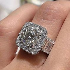 a woman's hand with a diamond ring on top of her finger and an engagement band