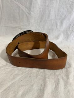 "Measurements in inches: Long: 46\" Deep: 1\"7 First perforation from buckle is 34\" and 40\" on the last Buckle measurements W: 5 H: 3\"2 Condition: -Good Pre-owned condition for its age -Buckle shows normal sings or wear from use -Belt is clean Shipping: -All purchases are sent within 1-2 business days -I send all the domestic purchases via USPS Priority mail and include a tracking number (emailed upon request). If you need an extra service please request it once you purchase your item -For in Classic Brown Belt For Ranch, Classic Leather Belt Buckles For Rodeo, Western Leather Belt For Western-themed Events, Leather Belt Buckles For Rodeo, Rustic Leather Belt For Rodeo, Rustic Leather Belt Buckles For Rodeo, Western Leather Belt Buckles For Rodeo, Classic Brown Belt Buckles For Western-themed Events, Classic Antique Belt Buckles For Ranch