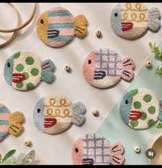 several embroidered fish are sitting on a table