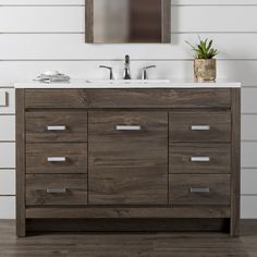 a bathroom vanity with two sinks and a mirror on the wall next to wood flooring