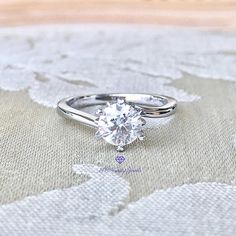 This pretty bypass solitaire ring is set with an excellent brilliant cut "hearts and arrows" D colorless Moissanite. Moissanites have become very popular. It is desired and preferred over a Diamond for it's sparkle and cost. As specified below this description the refractive index is a little higher on a Moissanite than on a Diamond. The lower cost of a Moissanite ring means you can wear it everyday, go anywhere you want to go with it and never fear losing lots of money should it get lost or sto Gia Certified Heart Cut Diamond Ring, Gia Certified Diamond White Promise Ring, Gia Certified Lab-grown Diamond Promise Ring, Heart Cut Lab-grown Diamond Ring With Diamond Cut, Gia Certified Round Cut Diamond Promise Ring, Gia Certified Round Cut Promise Ring, Gia Certified Round Diamond Ring For Anniversary, Gia Certified Heart Cut Diamond Anniversary Ring, Lab Grown Diamond Heart Cut Ring For Anniversary