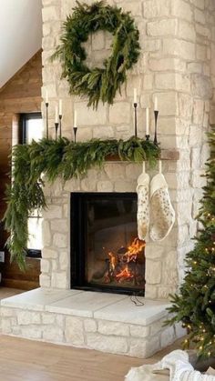 a living room with a fire place decorated for christmas