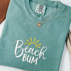 Beach Bum Shirt, Retro Comfort Colors T-Shirt, Trendy Beach Shirts for Women, Summer Vacation Shirts, Womens Oversized Beach Shirt  PLEASE NOTE THAT THE PICTURES ON THE LISTING ARE SAMPLES ONLY. If interested in adding embroidery to the sleeve please go to this listing: https://www.etsy.com/listing/1674502020 Because it is made to order, we don't accept the return or exchange unless we make a mistake We are unable to replace or refund purchases based on the color and the font selections. Please Green Cotton Shirt For Beach Season, Relaxed Fit Cotton T-shirt For Vacation, Casual Cotton Shirt For Vacation, Casual Cotton T-shirt For Vacation, Beachy Cotton T-shirt, Pre-shrunk, Beachy Cotton Pre-shrunk T-shirt, Beachy Cotton T-shirt Pre-shrunk, Beachy Cotton T-shirt, Green Crew Neck Beach Shirt