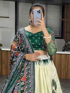 Elevate your ethnic wear collection with this beautiful off-white & green patola printed silk traditional lehenga choli. Crafted from high-quality dola silk material, this stunning ensemble features intricate patola and paithni printed work along with foil work (crush work) that adds a touch of elegance and sophistication. The off-white lehenga is paired with a green color dola silk choli and a matching dupatta, making it a perfect choice for weddings, festivals, or any special occasion.
Thi White Bandhani Print Sets With Traditional Drape, Anarkali White Set With Meenakari Details, Anarkali White Sets With Meenakari, Ikat Print Choli For Navratri With Traditional Drape, Traditional Ikat Print Choli For Navratri, Traditional White Meenakari Choli, Traditional Multicolor Ikat Print Lehenga, Traditional Ikat Print Lehenga For Navratri, White Meenakari Lehenga For Navratri