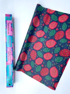 a piece of paper with fruit on it next to a pencil and ruler, which are both pink and green