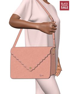 a woman holding a pink purse with scalloped edges