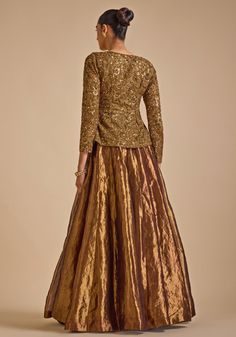 Step into elegance with Gold Embroidered Jacket Set. Crafted from luxurious blended silk, this stunning jacket features intricate zardozi and sequin embroidery detailing that exudes sophistication. The jacket's opulent design is perfectly complemented by a flared skirt, creating a harmonious blend of tradition and contemporary style. A perfect indo western outfit a bride or bride to be for Cocktail parties or Reception Night. Composition : Jacket - Blended Silk, Skirt - Tissue Care: Dry Clean On Traditional Tissue Silk Evening Set, Traditional Evening Sets In Tissue Silk, Traditional Evening Tissue Silk Sets, Evening Traditional Wear With Resham Embroidery In Tissue Silk, Silk Anarkali Traditional Evening Wear, Embellished Fitted Raw Silk Lehenga, Hand Embellished Sharara For Formal Parties, Embellished Art Silk Elegant Lehenga, Embellished Silk Lehenga For Reception