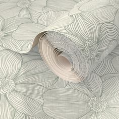 an artistic wallpaper with white flowers and lines on the paper, as well as a roll of tape