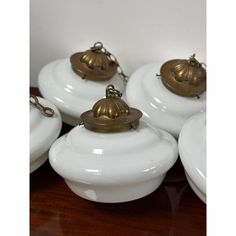 several white dishes with brass bells on them