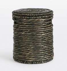 a round wicker basket with rope wrapped around the top and bottom, on a white background