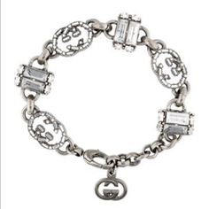 Gucci Crystal Embellished “Gg” Link Charm Bracelet Silver Tone Metal And Crystal Adjustable Lobster Clasp Closure It Has A Small Crack In One Of The Crystals Where Crystal Is Missing - Shown In Last Photo Make An Offer! Designer Metal Jewelry, Designer Jewelry Bracelet With Logo Charm, Elegant Silver Bracelet With Logo Charm, Designer Logo Charm Bracelet Jewelry, Luxury Metal Bracelets With Jewels, Designer Metal Bracelets With Logo Charm, Luxury Silver Jewelry With Logo Charm, Gucci White Gold Bracelet, Designer Silver Bracelets With Logo Charm