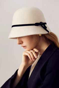 Elegant Vintage Wool with Chic Bow Embrace timeless fashion with our French-Inspired Wool Cloche Hat. Crafted from luxurious 100% high-quality merino wool, this hat combines exceptional warmth and breathability. Its natural luster adds a sophisticated charm, perfect for elevating any outfit. Inspired by Audrey Hepburn's classic style, this cloche hat is not just a headwear but a fashion statement, blending seamlessly with both contemporary and vintage aesthetics. Style #: WWAI5A3 Luxury Beige Elegant Cloche Hat, Luxury Beige Cloche Hat, Elegant Wool Fedora For Winter, Chic Wool Fedora For Winter, Chic Winter Wool Fedora, Elegant Wool Felt Hat For Fall, Elegant Fur Felt Hat For Winter, Winter Cloche Hat With Flat Brim, Elegant Wide Brim Winter Fedora