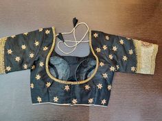 Stunning black designer sari blouse with golden floral embroidery. Shop designer saree blouse online in USA from Pure Elegance. Disclaimer: The actual product may vary slightly from the image. These are custom orders, hence expect slight variation in color, placement of the motif or buta. ESTIMATED DELIVERYBecause this is a custom order, it would take about 2 weeks from the date of purchase. RETURN POLICY: This product is a custom order and cannot be returned or exchanged. Semi-stitched Black Art Silk Blouse Piece, Black Cutdana Blouse For Reception, Black Blouse With Resham Embroidery For Festivals, Black Blouse With Traditional Drape For Eid, Black Traditional Drape Blouse For Eid, Black Traditional Drape Blouse For Reception, Black Embroidered Blouse Piece For Festive Occasions, Festive Black Embroidered Blouse Piece, Festive Embroidered Black Blouse Piece