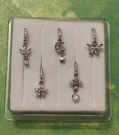 six pairs of earrings in a display case