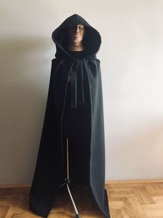 Black Wool Hooded Cloak, Wool Hooded Coat, Halloween Cape, Wool Hooded Cape, Medieval Cape, Autumn Cloak This coat is fastened with tying around the neck Please choose length Standard length is 145 cm (57 inches) Possible to produce length from the top of shoulders: 140 cm (55 inches), perfect for height 155-160 cm (61 inches - 63 inches) Price will not change for Lengths: 150 cm - 59 inches 160 cm - 63 inches 170cm - 67 inches 180cm - 71 inches Shipping terms to USA, United Kingdom, Canada - 25 Black Outerwear For Larp Halloween, Hooded Halloween Costume Outerwear, Black Long Sleeve Cape For Halloween, Fitted Cosplay Cape, Fitted Cape For Cosplay, Black Halloween Outerwear With Drawstring Hood, Black Hooded Cape For Costume Party, Halloween Cape Outerwear For Larp, Black Outerwear With Drawstring Hood For Halloween