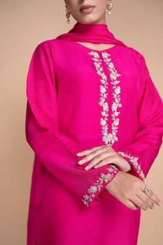 Handmade and fully stitched outfit for a personalized touch Chic V-neck kurta paired with a matching trouser pant and dupatta Luxurious silk fabric in a delightful shade of pink Exquisite embroidery featuring Resham thread and pearl detailing Elevate your style with the perfect blend of comfort and sophistication A versatile ensemble that effortlessly transitions from day to night Color may differ due to camera resolution. Delivery may take 4-5 weeks, In case of Urgency please drop us a message or mention the date at the time of order. For any kind of customization please message us, we will assist you. Care Instructions : Each product of ours is designed with highest quality standards and delicacy. Handle with care. Dry clean only. Pakistani Suits Ideas, Pearl Dupatta, V Neck Kurti Design, Fuchsia Outfit, Embroidered Trousers, Designer Ethnic Wear, Kurti Embroidery Design, Cotton Kurti Designs, Dress Neck Designs