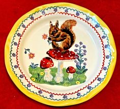 a yellow and white plate with a small squirrel on it's back sitting on top of a mushroom