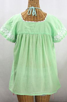 "* Ornate hand embroidery and smocking with hand crocheted trim on the neck and open sleeve hems, available here in PALE GREEN with WHITE embroidery. * Light, gauzy and semi-sheer 100% cotton throughout; wear it billowy and flowing in the bohemian style, or belted for a more fitted look. * Dyed, distressed and embroidered by hand for an authentic, retro-vintage and boho-chic hippie vibe. * Our colorful and ornate floral embroidery patterns are a faithful tribute to the traditional hippie peasant Cotton Peasant Top With Embroidered Hem, Cotton Peasant Top With Embroidered Neckline And Short Sleeves, Cotton Peasant Top With Embroidered Hem And Short Sleeves, Peasant Cotton Dress With Short Sleeves, Short Sleeve Cotton Peasant Dress, Cotton Short Sleeve Peasant Top With Embroidered Hem, Traditional Cotton Peasant Top With Embroidered Hem, Folk Style Short Sleeve Peasant Top With Embroidered Border, Green Cotton Peasant Top With Short Sleeves